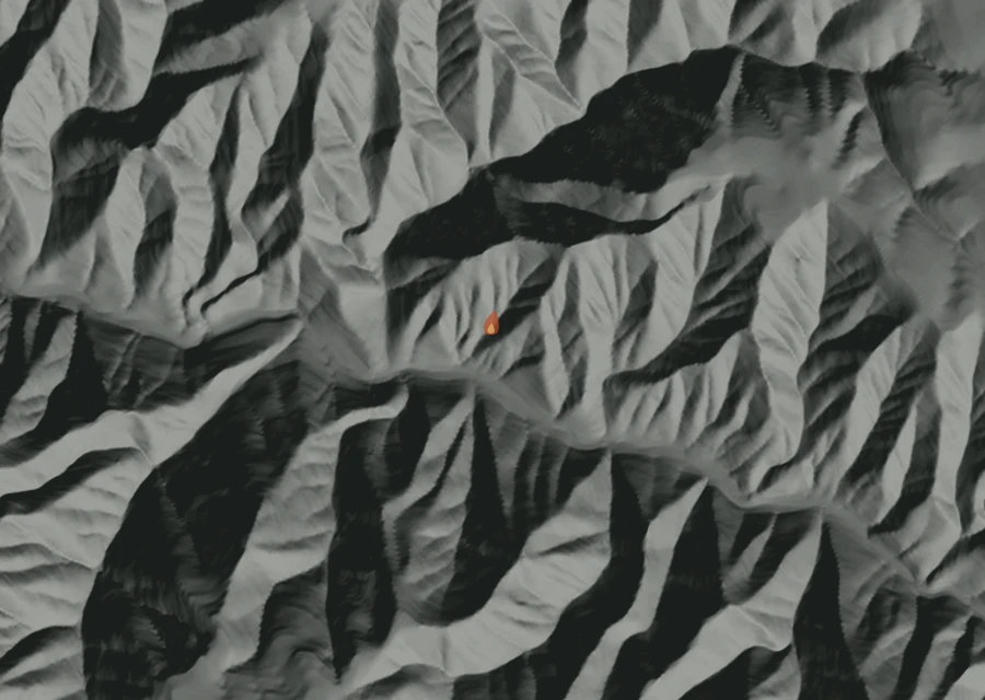 Shaded relief map of the Ruchert Fire. Amber flames mark every place that gave off heat in the last day; the shading is the shape of the ground.