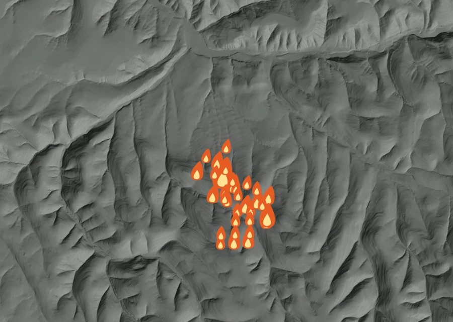 Shaded relief map of the Ruggs Fire. Amber flames mark every place that gave off heat in the last day; the shading is the shape of the ground.