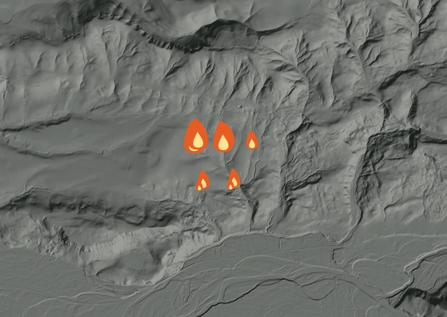 Shaded relief map of the Section 12 Fire. Amber flames mark every place that gave off heat in the last day; the shading is the shape of the ground.