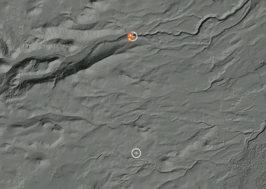 Shaded relief map of the Sno Park Fire. Amber flames mark every place that gave off heat in the last day; the shading is the shape of the ground.