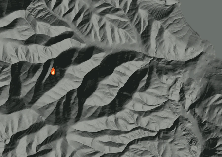 Shaded relief map of the Stormy Mountain Fire. Amber flames mark every place that gave off heat in the last day; the shading is the shape of the ground.