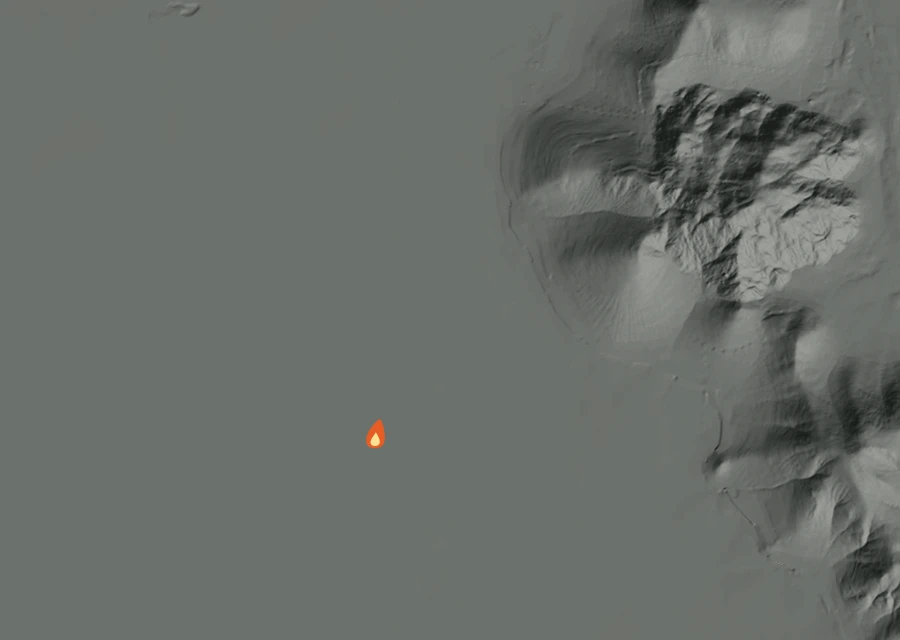 Shaded relief map of the Swan Fire. Amber flames mark every place that gave off heat in the last day; the shading is the shape of the ground.