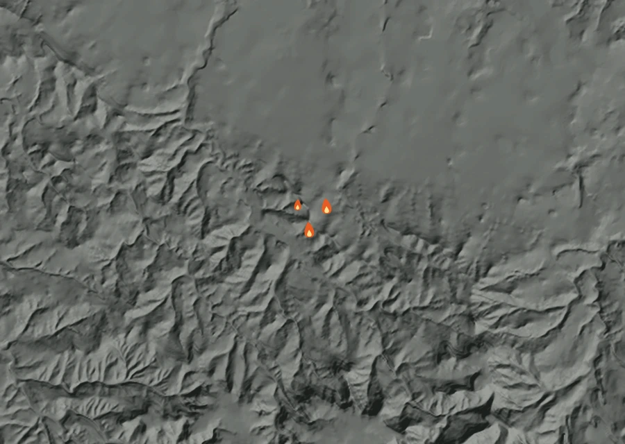 Shaded relief map of the Swanski Fire. Amber flames mark every place that gave off heat in the last day; the shading is the shape of the ground.