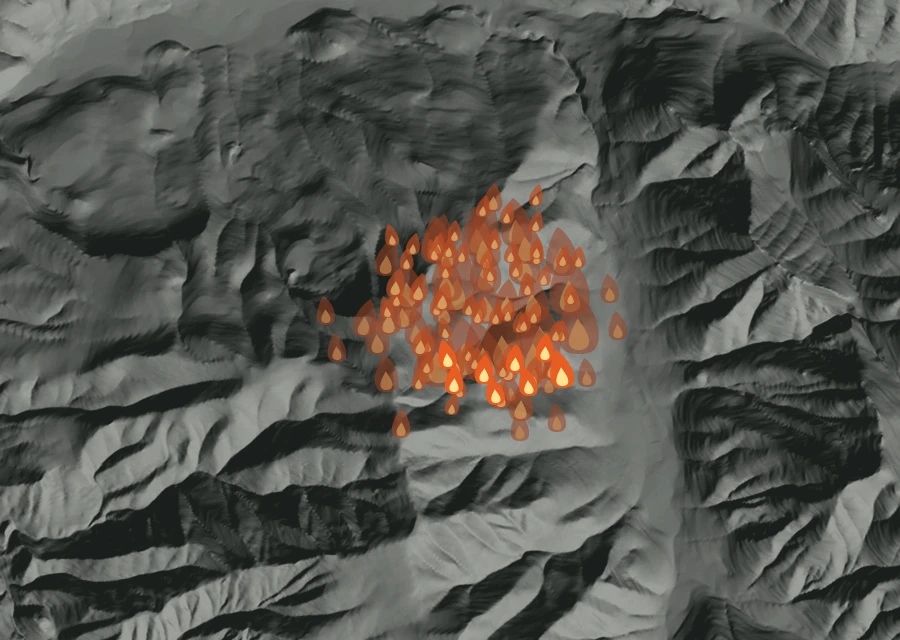 Shaded relief map of the Swiss Roll Fire. Amber flames mark every place that gave off heat in the last day; the shading is the shape of the ground.