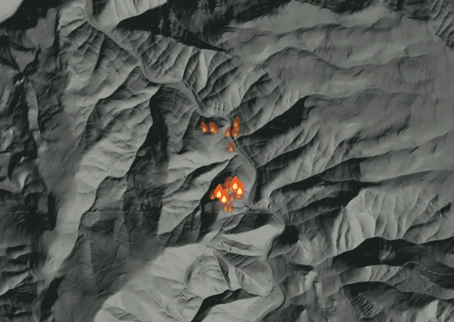 Shaded relief map of the The Narrows Fire. Amber flames mark every place that gave off heat in the last day; the shading is the shape of the ground.