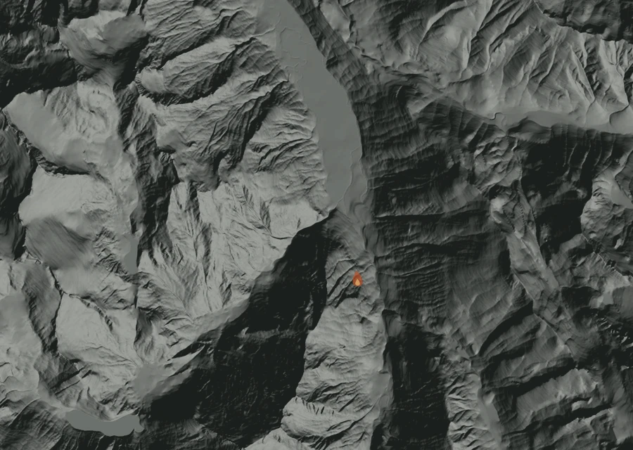 Shaded relief map of the Thunder Creek Fire. Amber flames mark every place that gave off heat in the last day; the shading is the shape of the ground.