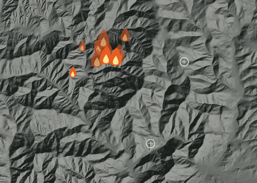 Shaded relief map of the W Fork Evans Creek Fire. Amber flames mark every place that gave off heat in the last day; the shading is the shape of the ground.