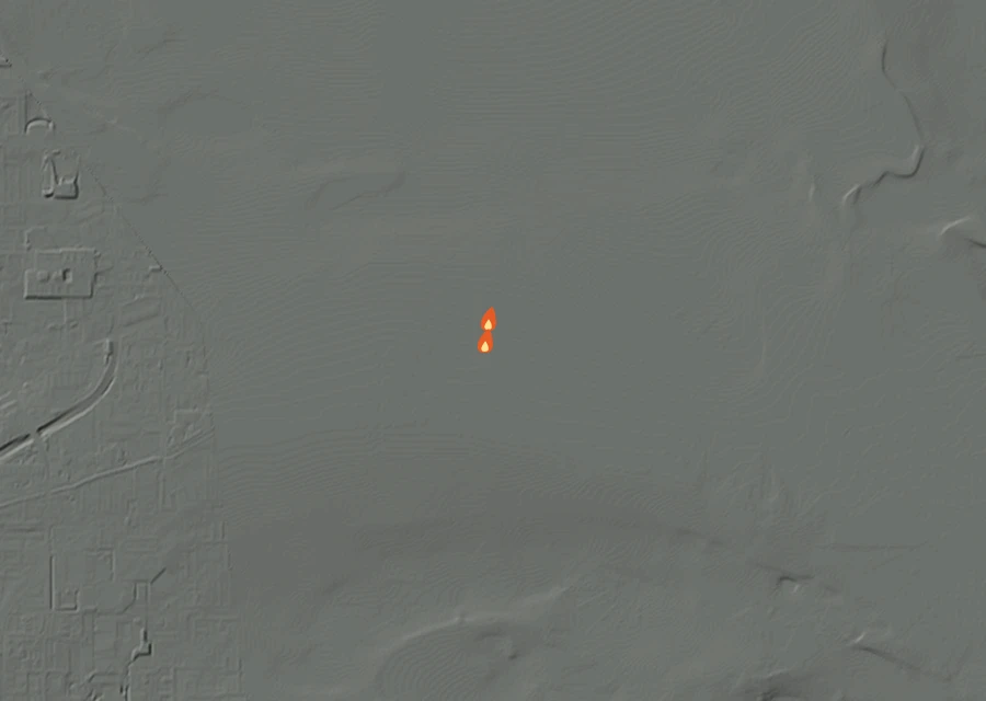 Shaded relief map of the Warehouse Fire. Amber flames mark every place that gave off heat in the last day; the shading is the shape of the ground.