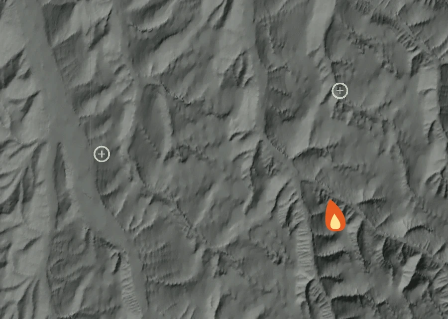 Shaded relief map of the Whiskey Creek Fire. Amber flames mark every place that gave off heat in the last day; the shading is the shape of the ground.