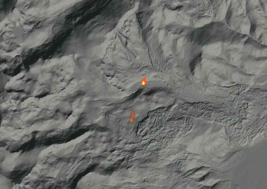 Shaded relief map of the Willow Fire. Amber flames mark every place that gave off heat in the last day; the shading is the shape of the ground.