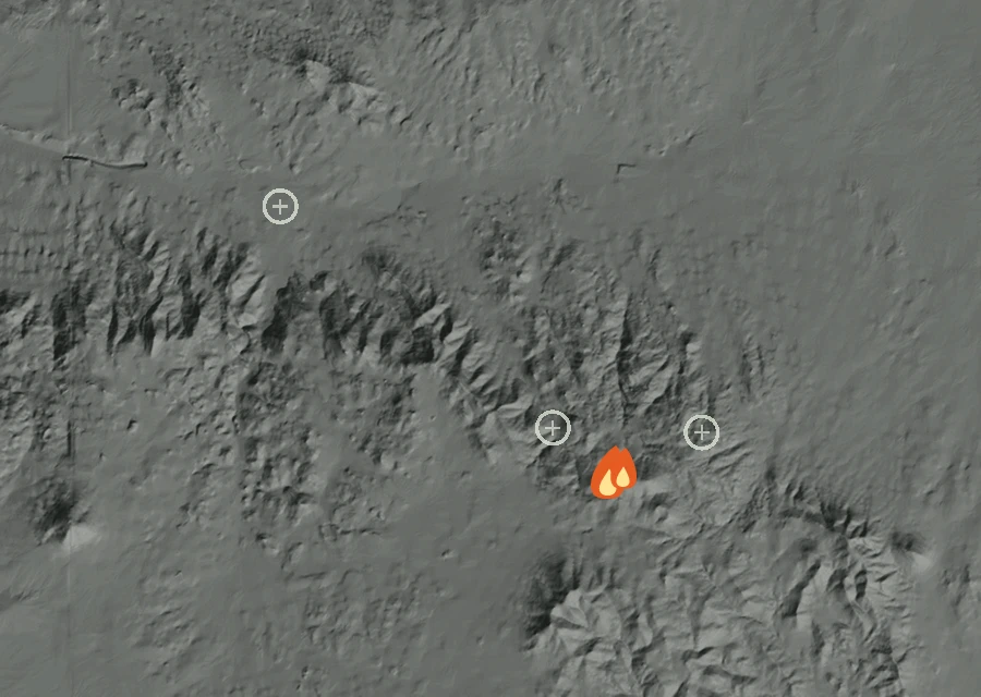 Shaded relief map of the Wood Fire. Amber flames mark every place that gave off heat in the last day; the shading is the shape of the ground.